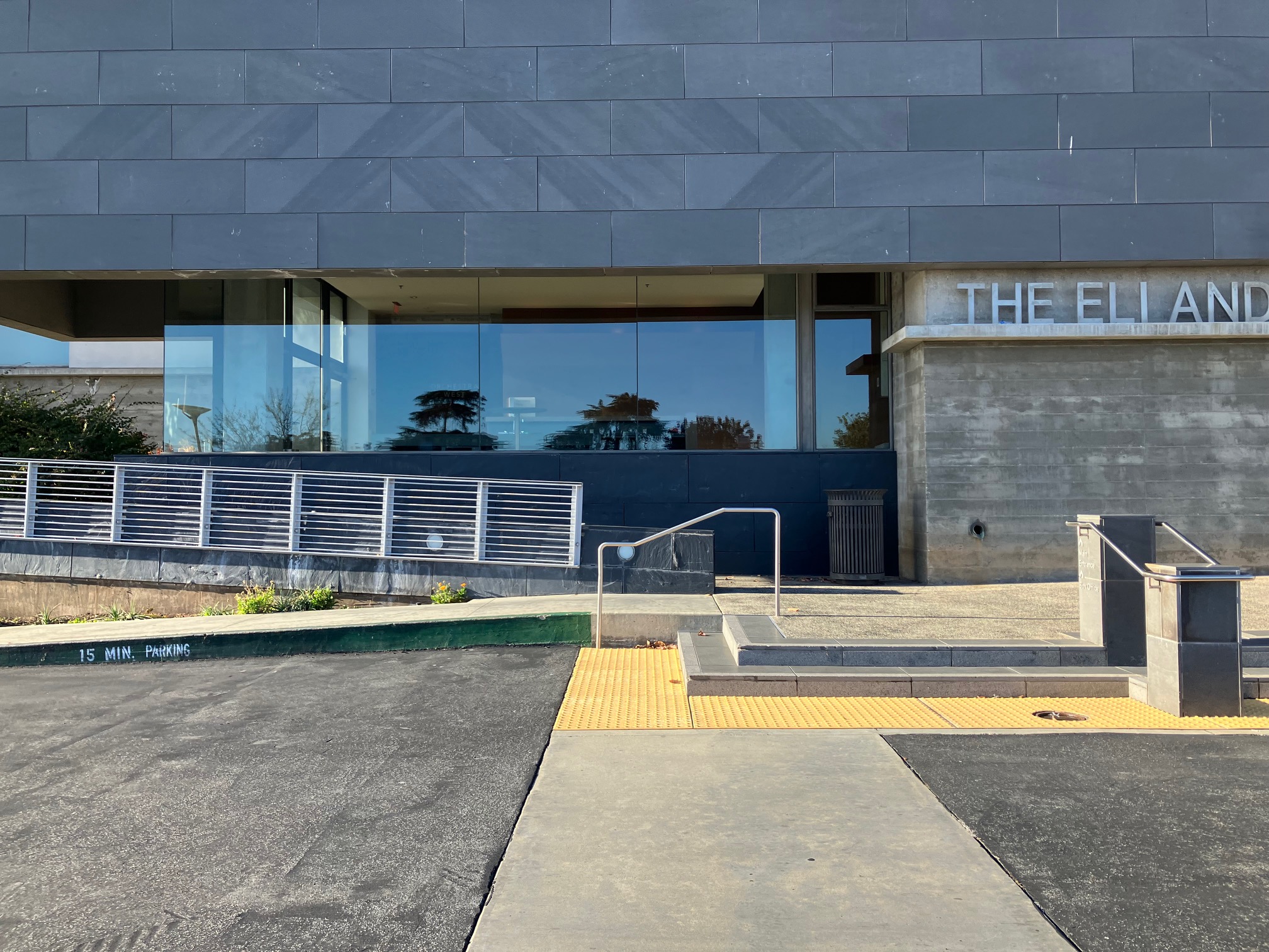 Accessible entrance from the parking area. The entrance to Eli and Edythe BroadStage building has steps on the right, and a ramp on the left.  